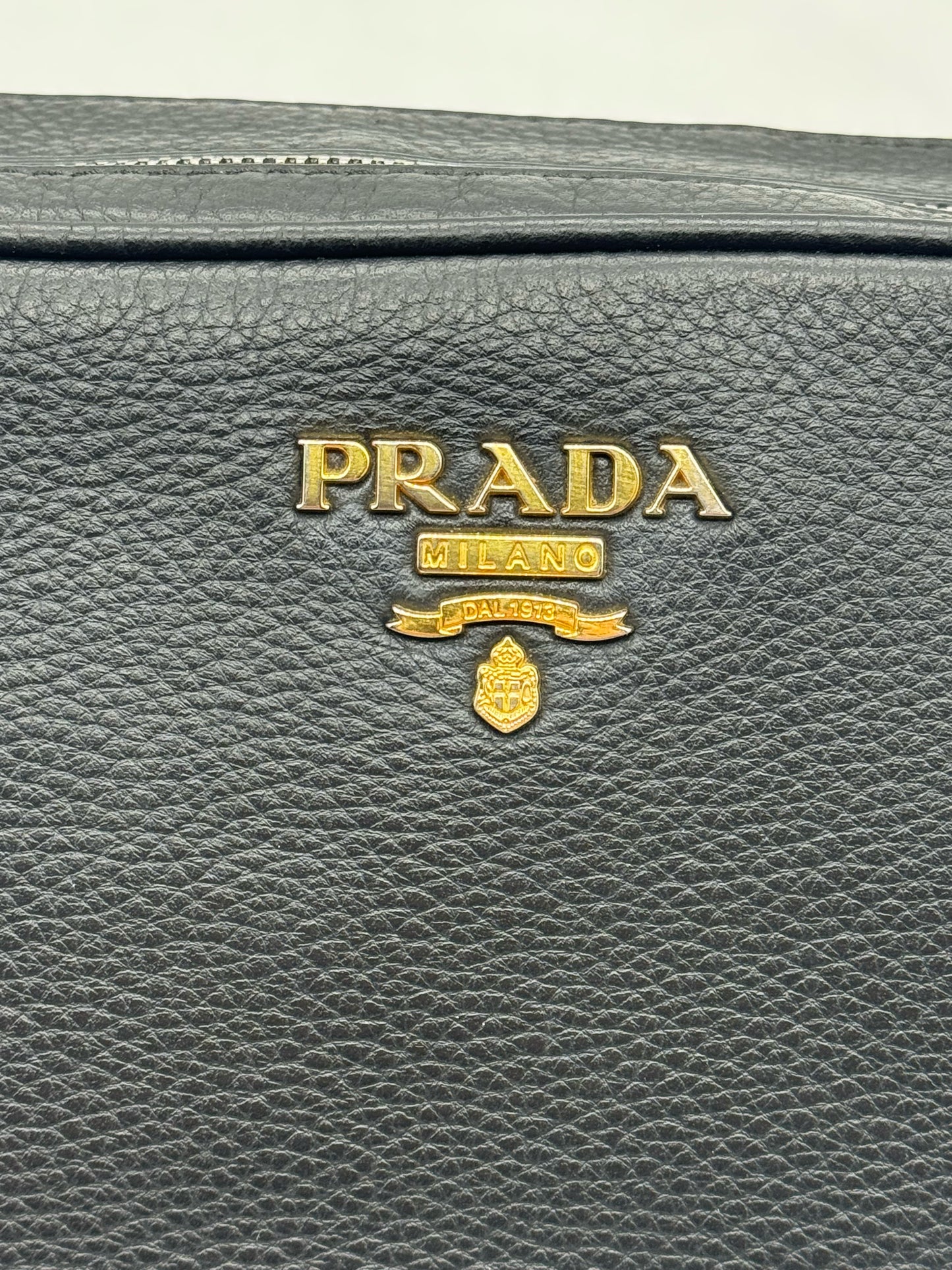 Dettaglio del logo Prada Milano in metallo dorato su borsa Borse Vintage in pelle nera martellata Vitello Phenix