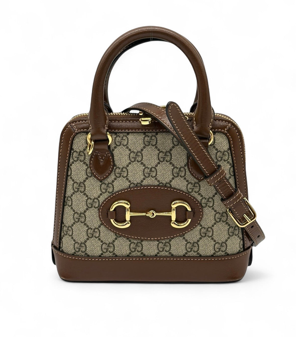 Borsa Gucci Horsebit 1955 Top Handle GG Supreme marrone con dettagli in pelle e metallo dorato, modello a mano e tracolla autentico.