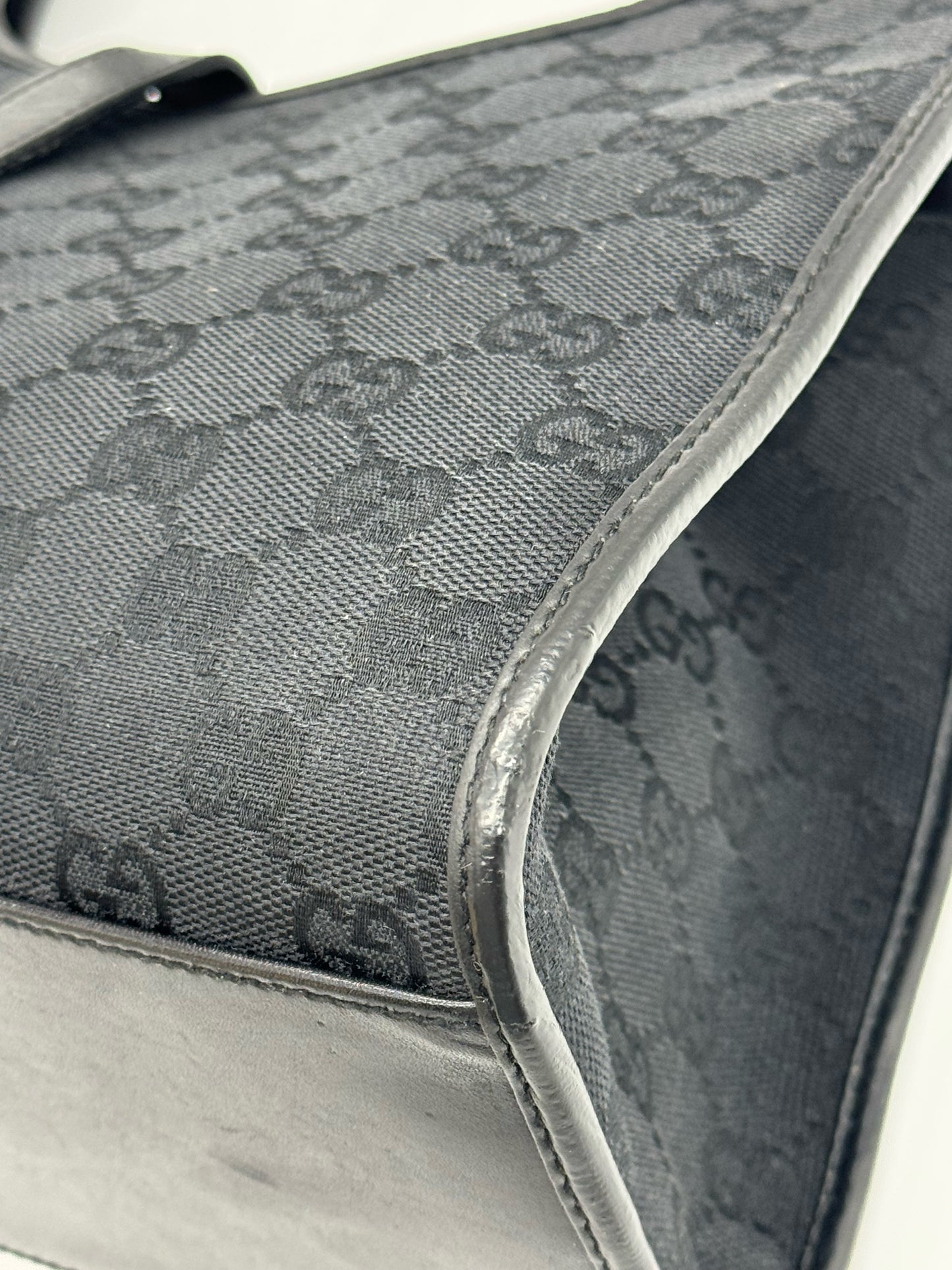 Dettaglio della borsa a spalla Borse Vintage Gucci Jackie in tessuto nero con iconico motivo GG e finiture in pelle
