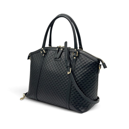 Borsa a mano Borse Vintage Gucci in pelle nera con motivo GG impresso, dettagli dorati e tracolla rimovibile.