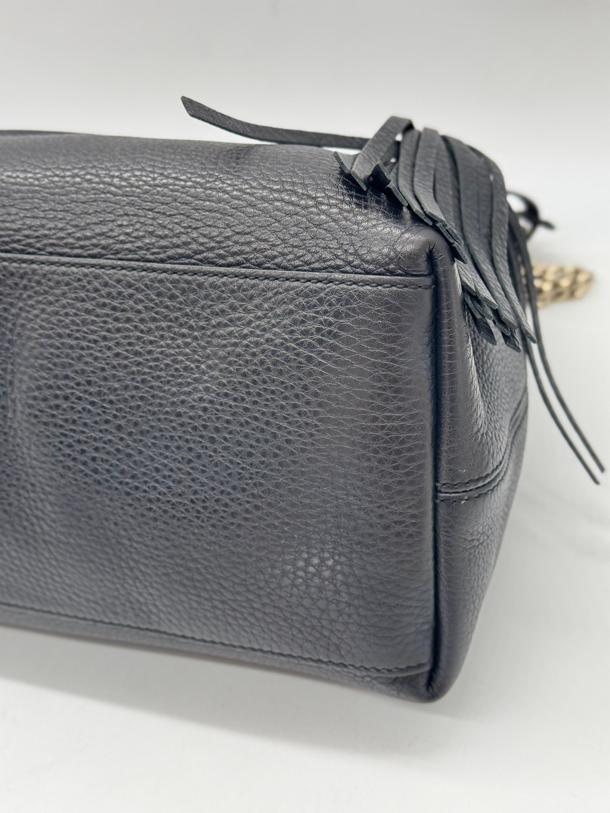 Dettaglio laterale della borsa a spalla Borse Vintage in pelle nera martellata con nappa decorativa e catena dorata