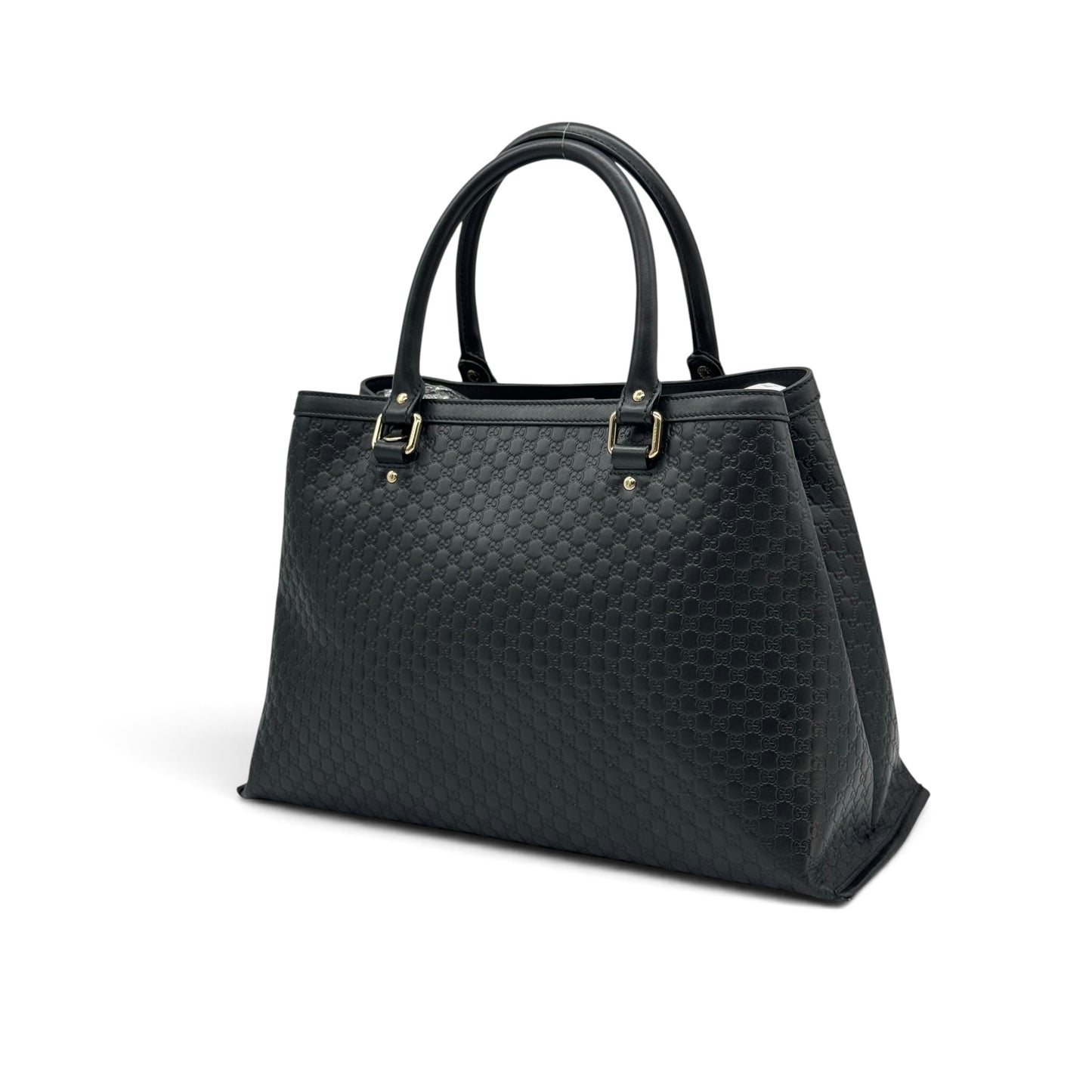 Borsa tote Borse Vintage Gucci in pelle nera con motivo GG impresso e dettagli in metallo dorato su sfondo bianco