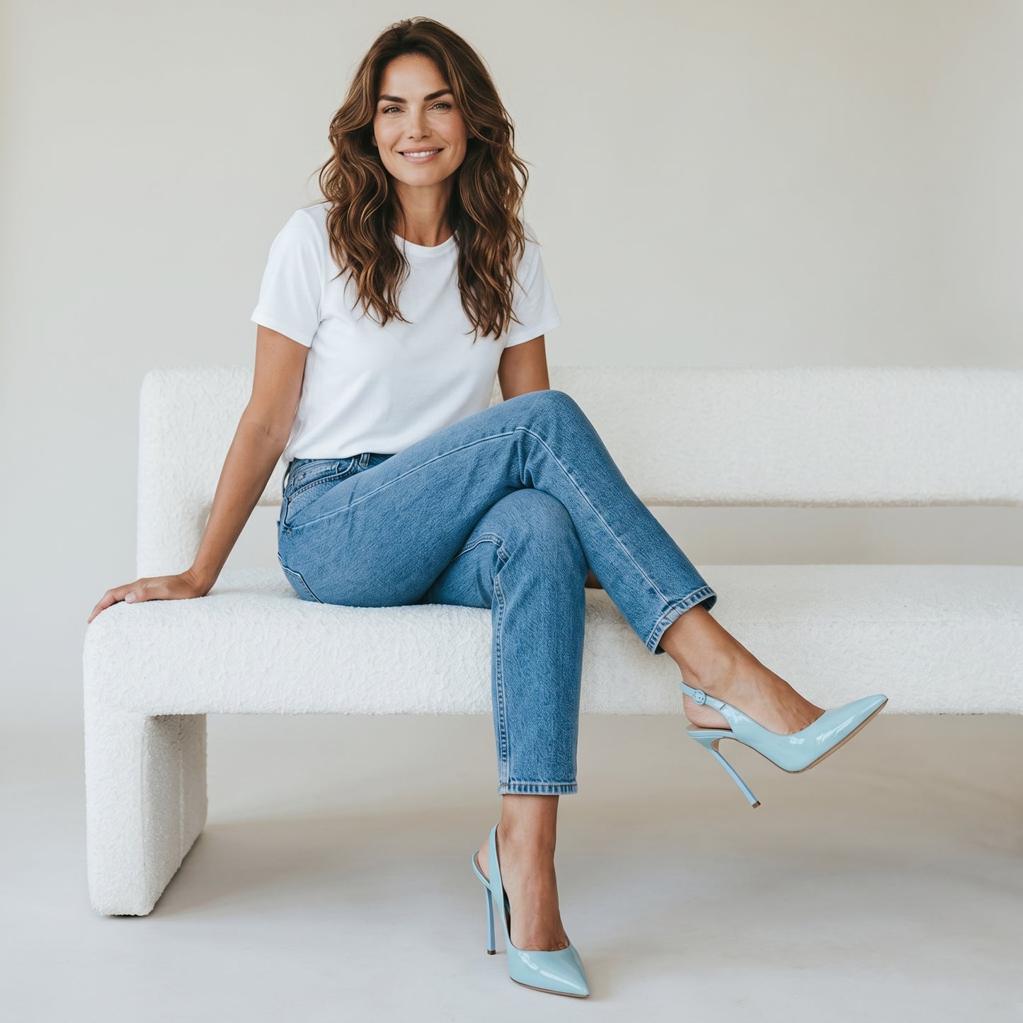 Modella seduta su divano bianco indossa décolleté slingback azzurre in vernice Borse Vintage con tacco a spillo